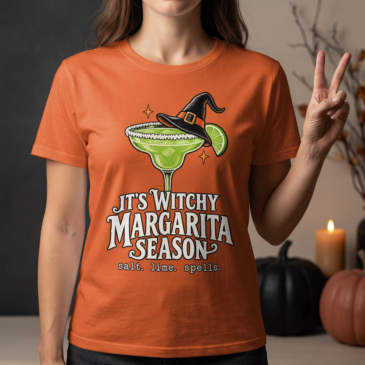 Orange t-shirt with a witch hat margarita graphic and text: "It's Witchy Margarita Season".