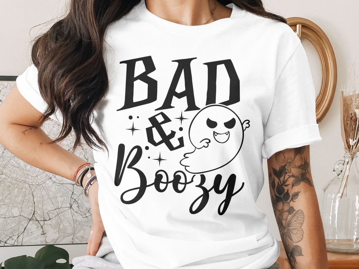 White t-shirt with black text "BAD & Boozy" and a cartoon ghost.