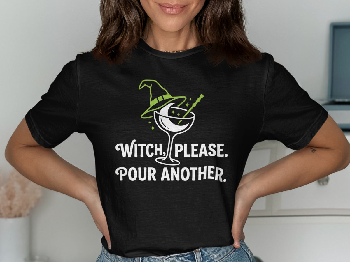 Black t-shirt with green witch hat and martini glass graphic, text reads "Witch, Please. Pour Another."