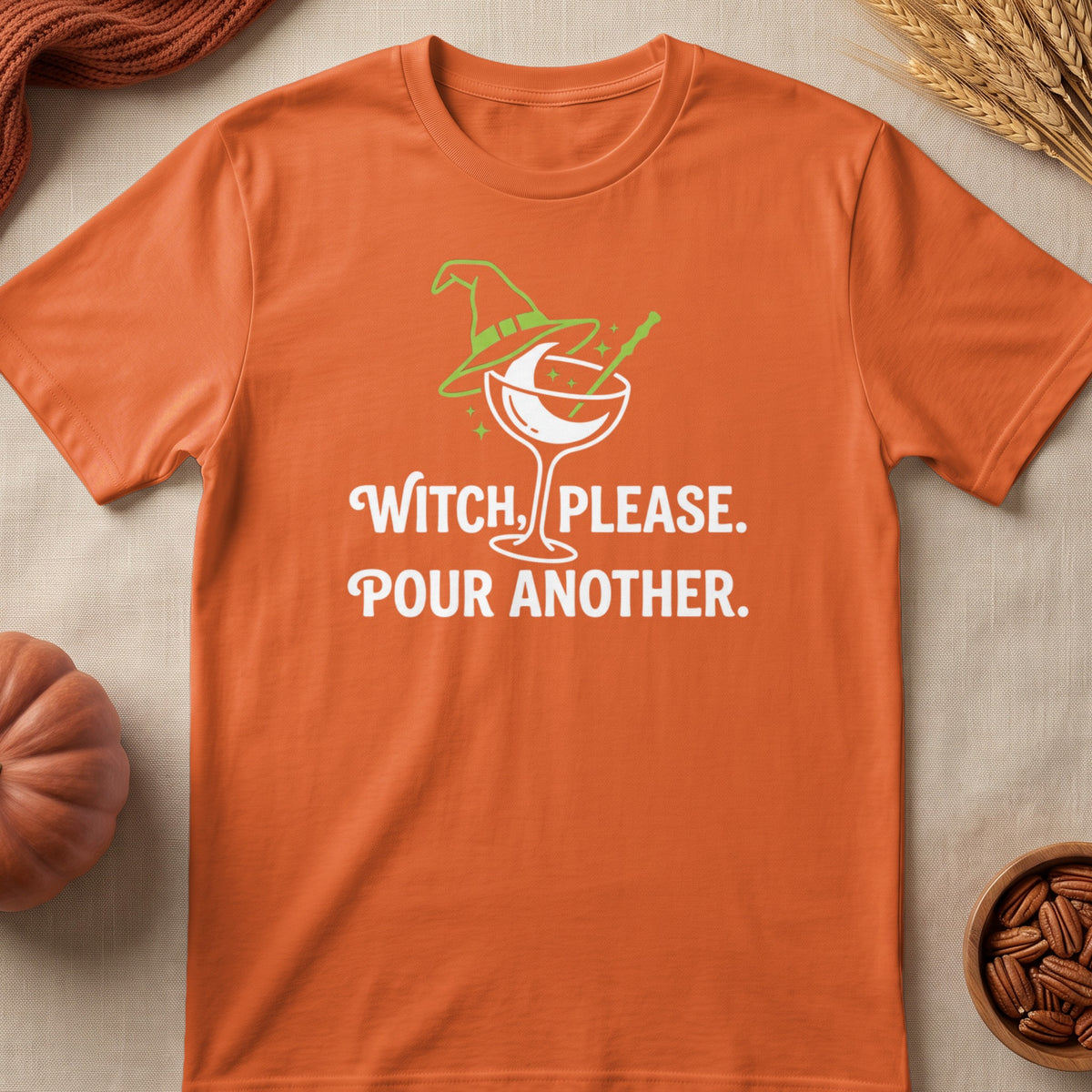 Orange t-shirt with "Witch, Please. Pour Another." text and witch hat cocktail graphic.