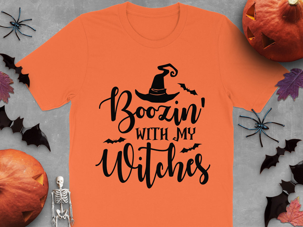 Orange t-shirt with black text that reads "Boozin' With My Witches".